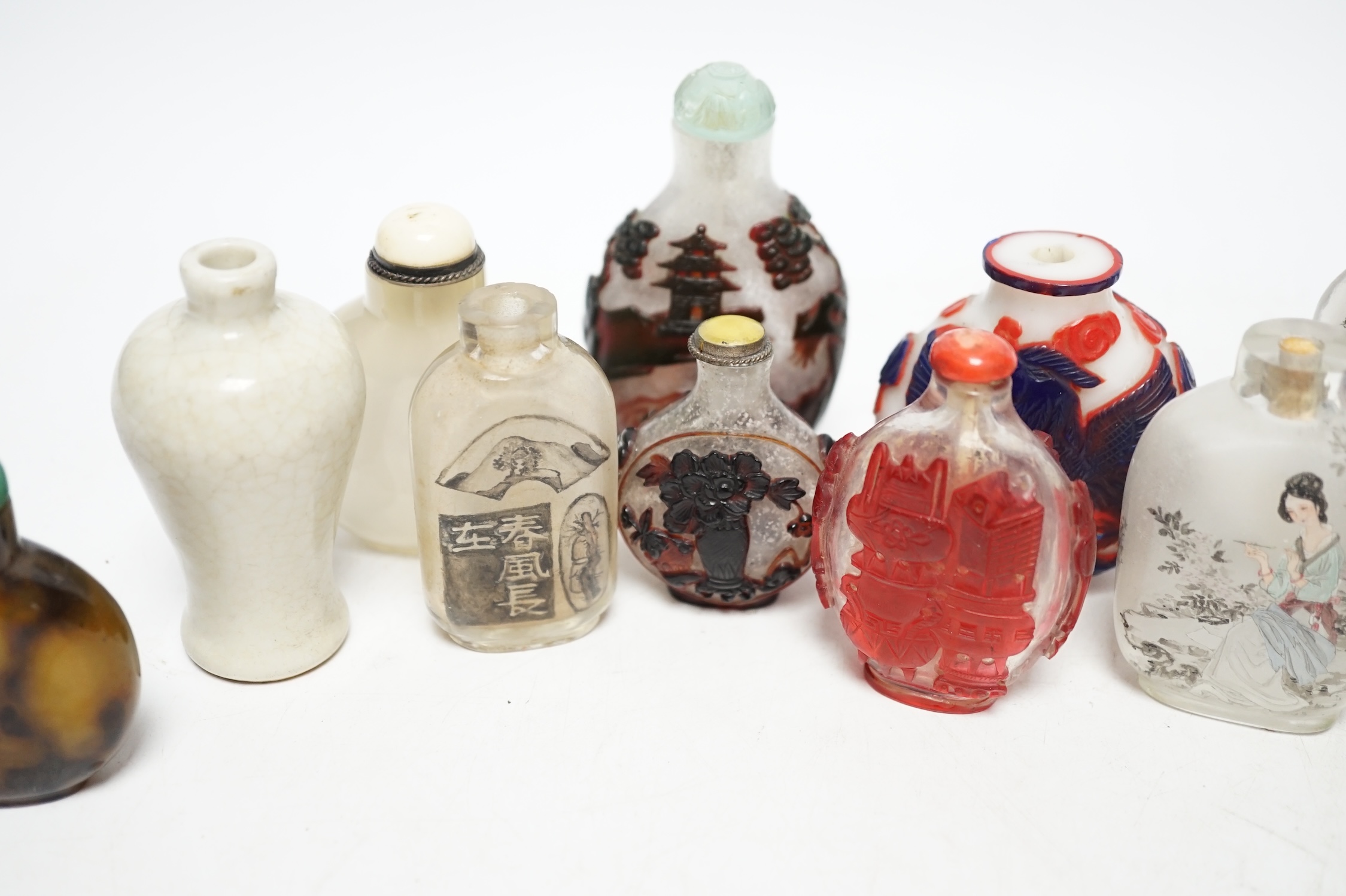 A group of Chinese cameo glass and inside painted glass and faux hardstone glass snuff bottles, largest 8.5cm high